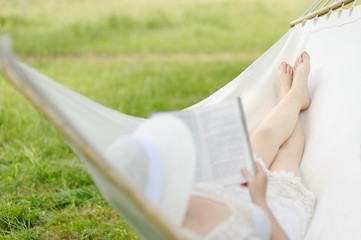 Wall Mural - Woman resting in hammock outdoors.