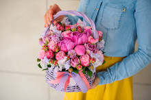 Girl Holding Beautiful Pink Bouquet Of Mixed Flowers In Basket