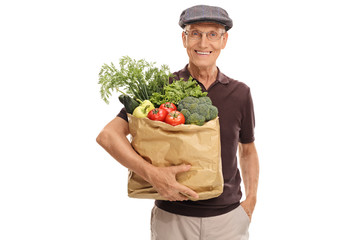 Wall Mural - Elderly man holding a bag of groceries