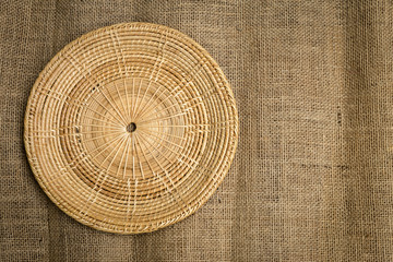 Wall Mural - Round rattan tray on hessian texture background