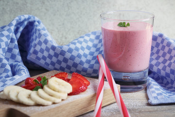 Delicious strawberry and banana smoothie or milk shake with fres