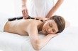 © WavebreakMediaMicro - Beautiful woman receiving hot stone massage