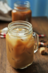 Wall Mural - Iced coffee with milk on wooden table