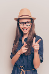 Sticker - Cheerful pretty girl in hat and glasses pointing on camera