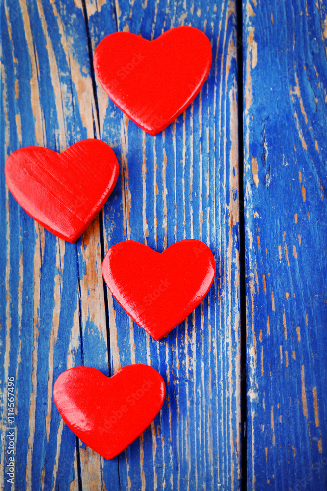 Wooden hearts on color wooden background