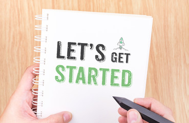 Let's get started word on white ring binder notebook with hand h