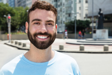 Fashionable caucasian man with beard outdoor in city