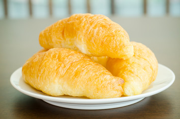 Croissant on white plate,breakfast,meal