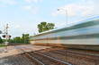 Passenger Train Cars Blur Along the Tracks