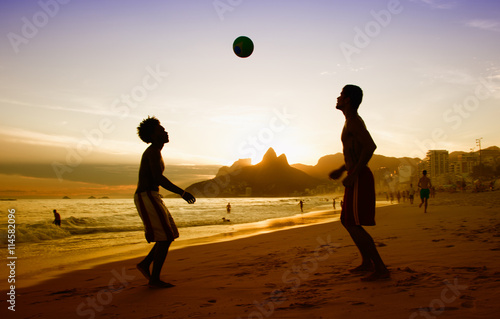 Obraz na plátně Two guys loves playing soccer at beach at Rio de Janeiro