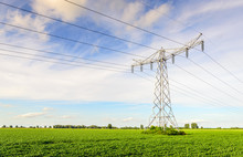 Power Lines And Pylons In A Large Potato Field