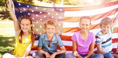  Children holding american flag in park