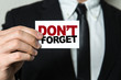 © gustavofrazao - Business man holding a card with the text: Don't Forget