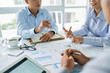 © DragonImages - Cropped image of business people discussing start-up project