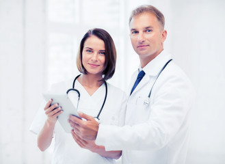 two doctors looking at tablet pc