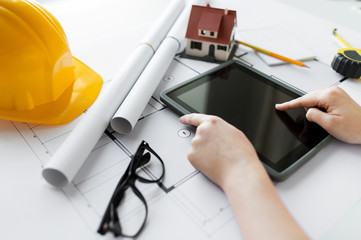 Poster - close up of hand with blueprint and tablet pc