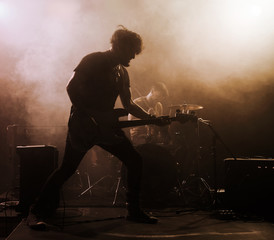 Poster - Rock band performs on stage. Guitarist.