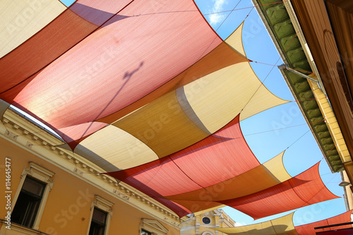 Fotografie, Obraz Street decorated with colored canvas awnings
