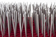 Bed of Nails - Pierced red velvet with metal nails in rows on a white background.