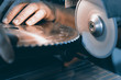 © allexxandarx - Sharpening Circular Saw, worker sharpens a circular saw blade