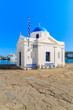 White church with blue dome in Mykonos port, Cyclades, Greece