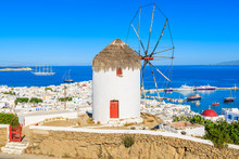 A View Of Famous Traditional Windmill Overlooking Mykonos Port, Island Of Mykonos, Cyclades, Greece