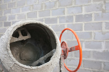The New Orange Cement Mixer At A Construction Site.