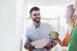 © Westend61 - Smiling businessman with colleagues analysing data