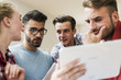© Westend61 - Young professionals looking at digital tablet
