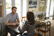© Monkey Business - Elevated view of couple talking at a table in a coffee shop