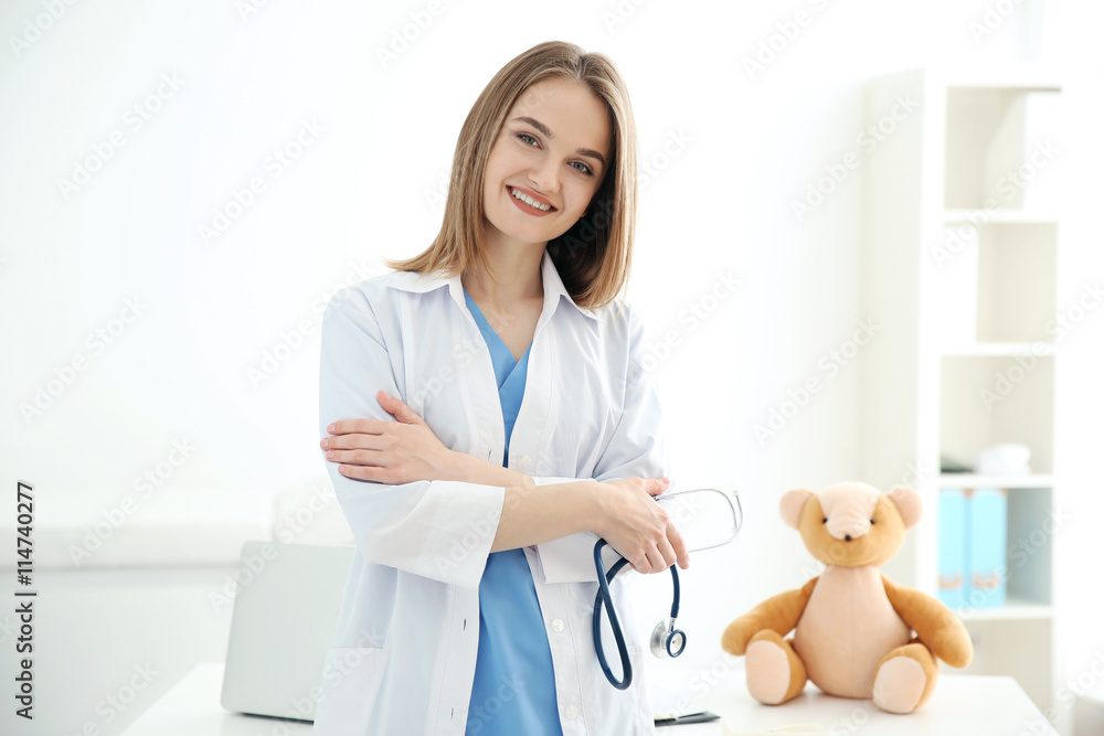 Young beautiful female doctor with stethoscope at the office