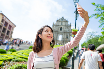 Wall Mural - Woman taking picture by mobile phone