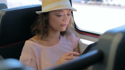 Poster - Young woman talking on the phone while traveling on the train