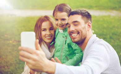 Poster - happy family taking selfie by smartphone outdoors