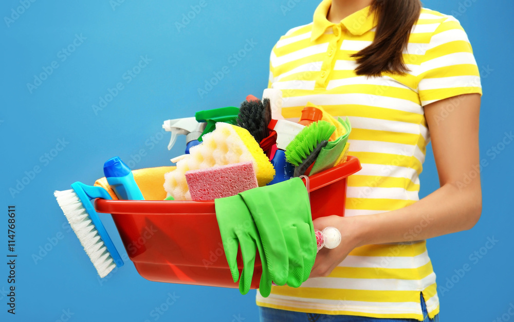 Female cleaner on blue background