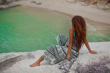 Wall Mural - sensitive young woman on the rock