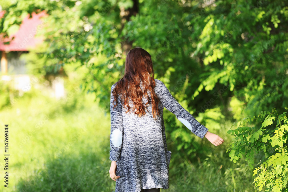 Young beautiful girl walking in park