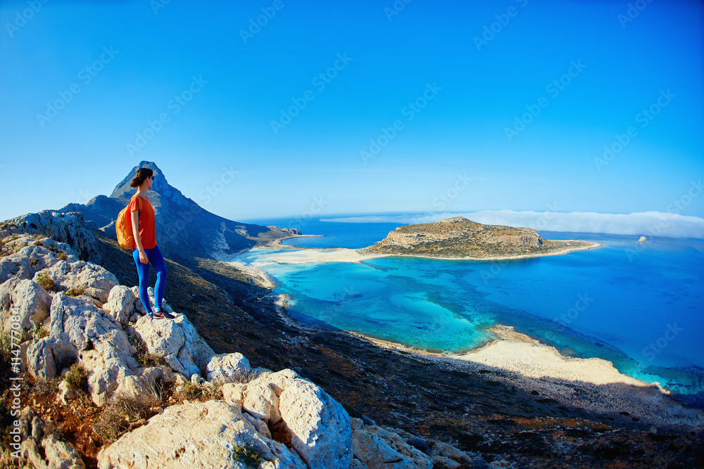 Obraz na płótnie panoramic view on Balos beach, Crete, Greece. Woman, traveller stands on the cliff against sea background w salonie