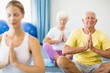 © WavebreakmediaMicro - Instructor performing yoga with seniors