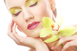 © Raisa Kanareva - young woman with bright make up holding orchid
