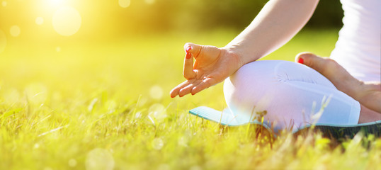 hand of woman meditating in lotus position practicing yoga