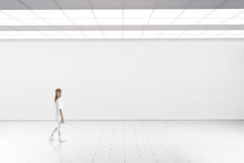 Empty Big Hall Wall Mockup. Woman Walk In Museum Gallery With Blank Wall. White Clear Stand Mock Up Lobby. Display Artwork Presentation. Art Design Empty Floor. Expo Studio Wall In Loft Corridor.