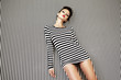 fashion woman in striped dress on  background