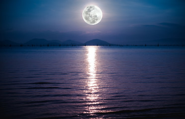 Wall Mural - romantic scenic with full moon on sea to night. reflection of moon in water.