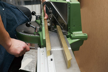 Wall Mural - Craftsman working on frame in frameshop.