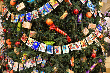 Wall Mural - Christmas tree decorated with Christmas balls, candy and garland of old postcards at State Department Store