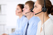 © rogerphoto - Call center operators. Young beautiful business woman in headset.
