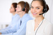 © rogerphoto - Call center operators. Young beautiful business woman in headset.