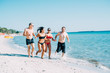 © Eugenio Marongiu - Group of multiethnic man and woman friends in summertime running on the beach hand in hand, smiling - friendship, summer, joyful concept