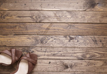 A Pair Of High Heeled Shoes On A Distressed Floorboard Background
